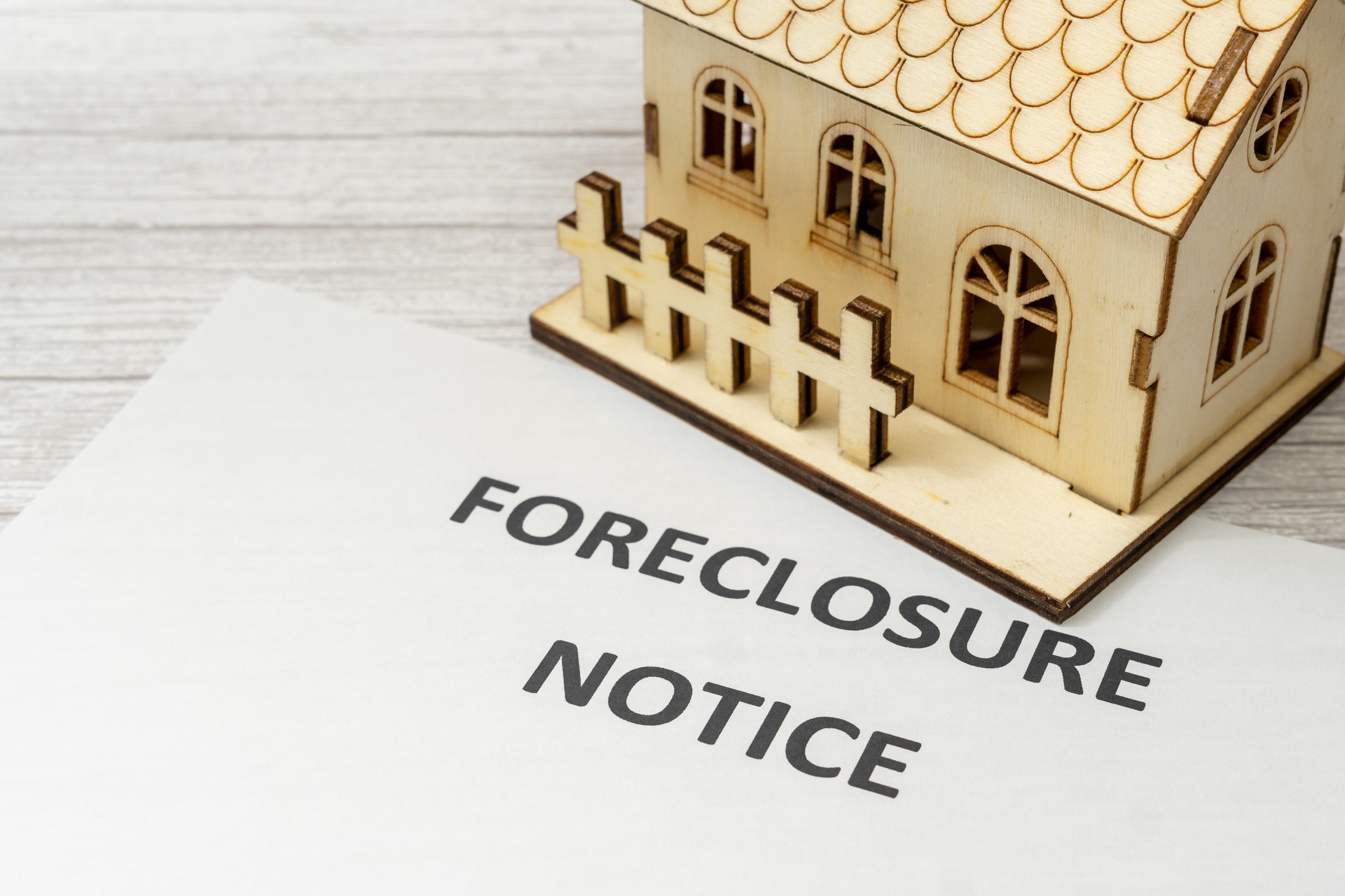 Notice of foreclosure of a house. Concept of eviction for non-payment of a mortgage to the bank. Rising interest rates. House next to the injunction